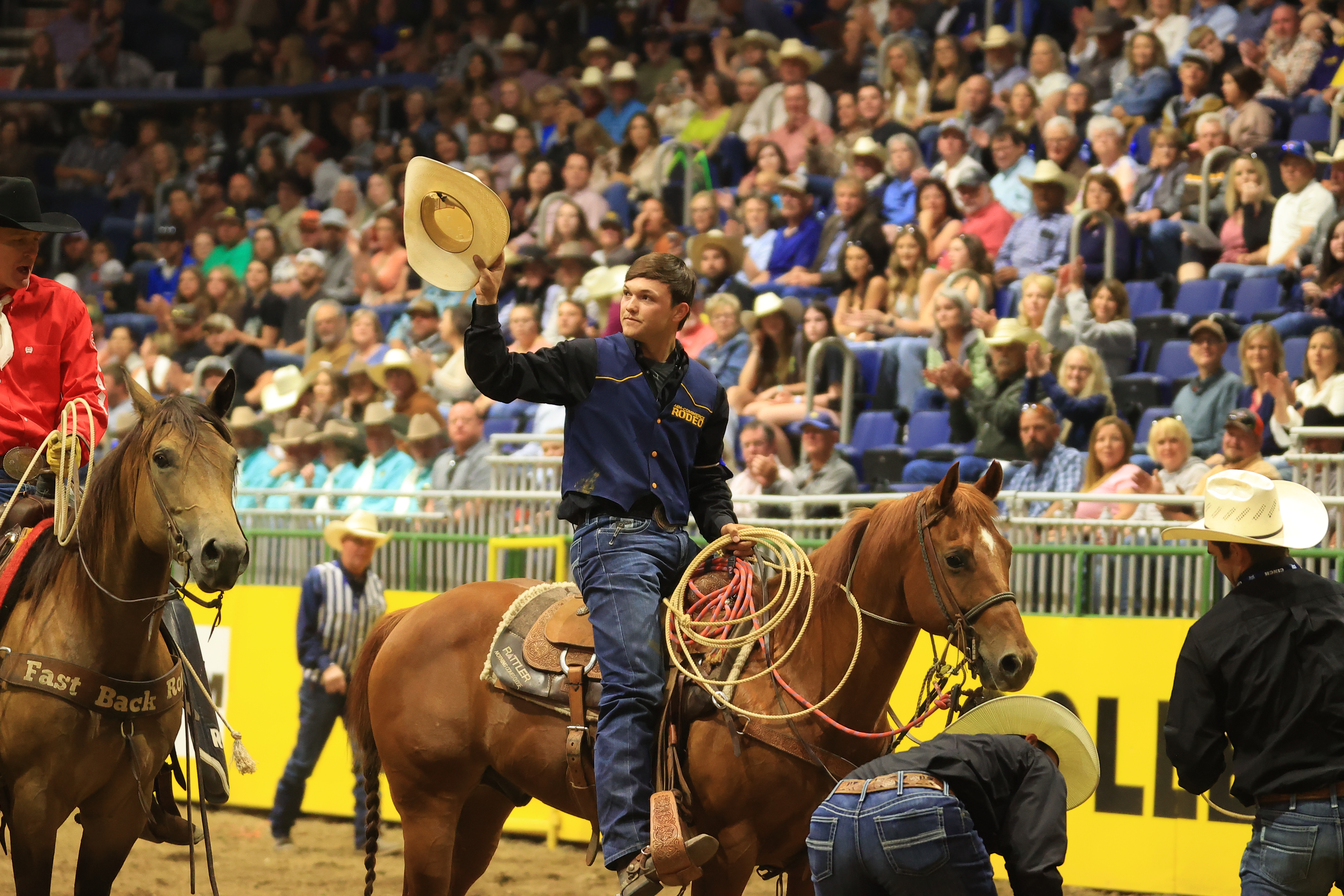 Kincade Henry waves his hat at the 2023 CNFR after winning the national title.