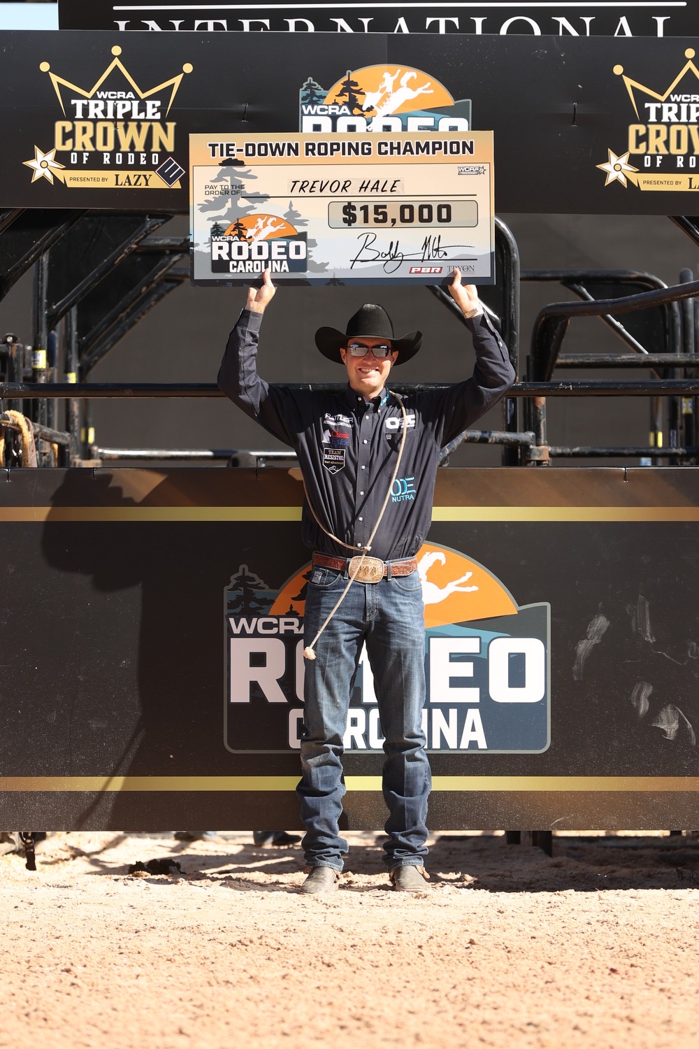 Trevor Hale poses with his $15,000-check after winning 2023 WCRA Rodeo Carolina.