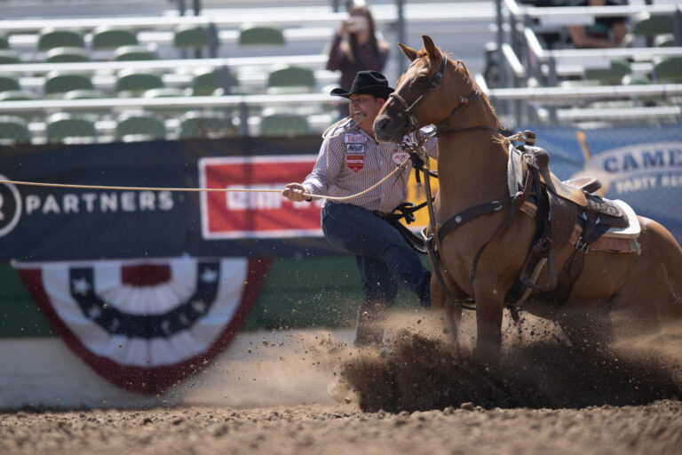 Westyn Hughes stepping off his horse at the 2023 Reno Rodeo.