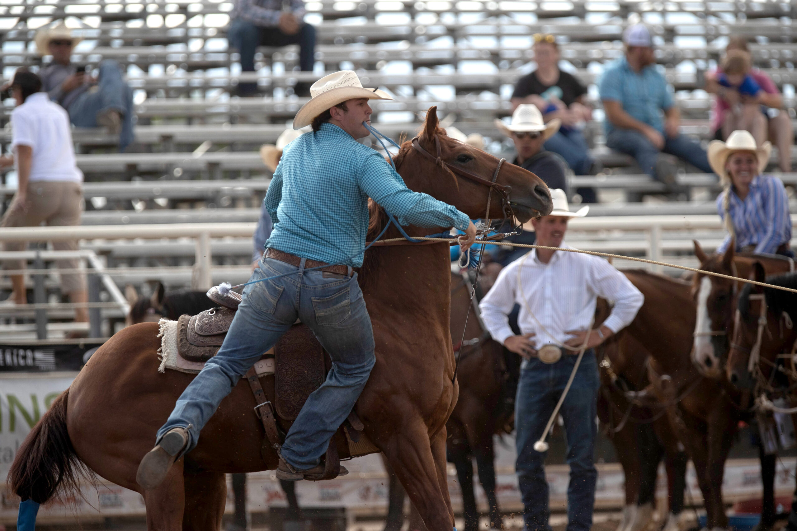 Professional tie-down roper Jake Hodnett competing in the arena with is horse, Big Red.